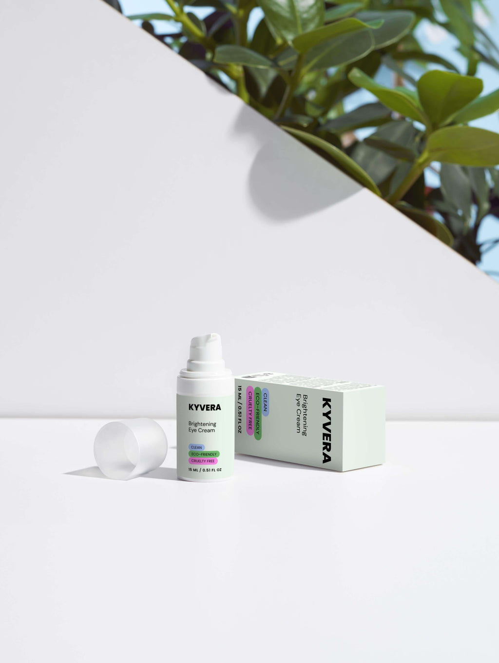 Brightening Eye Cream product in a sleek bottle with packaging, surrounded by vibrant green plants.