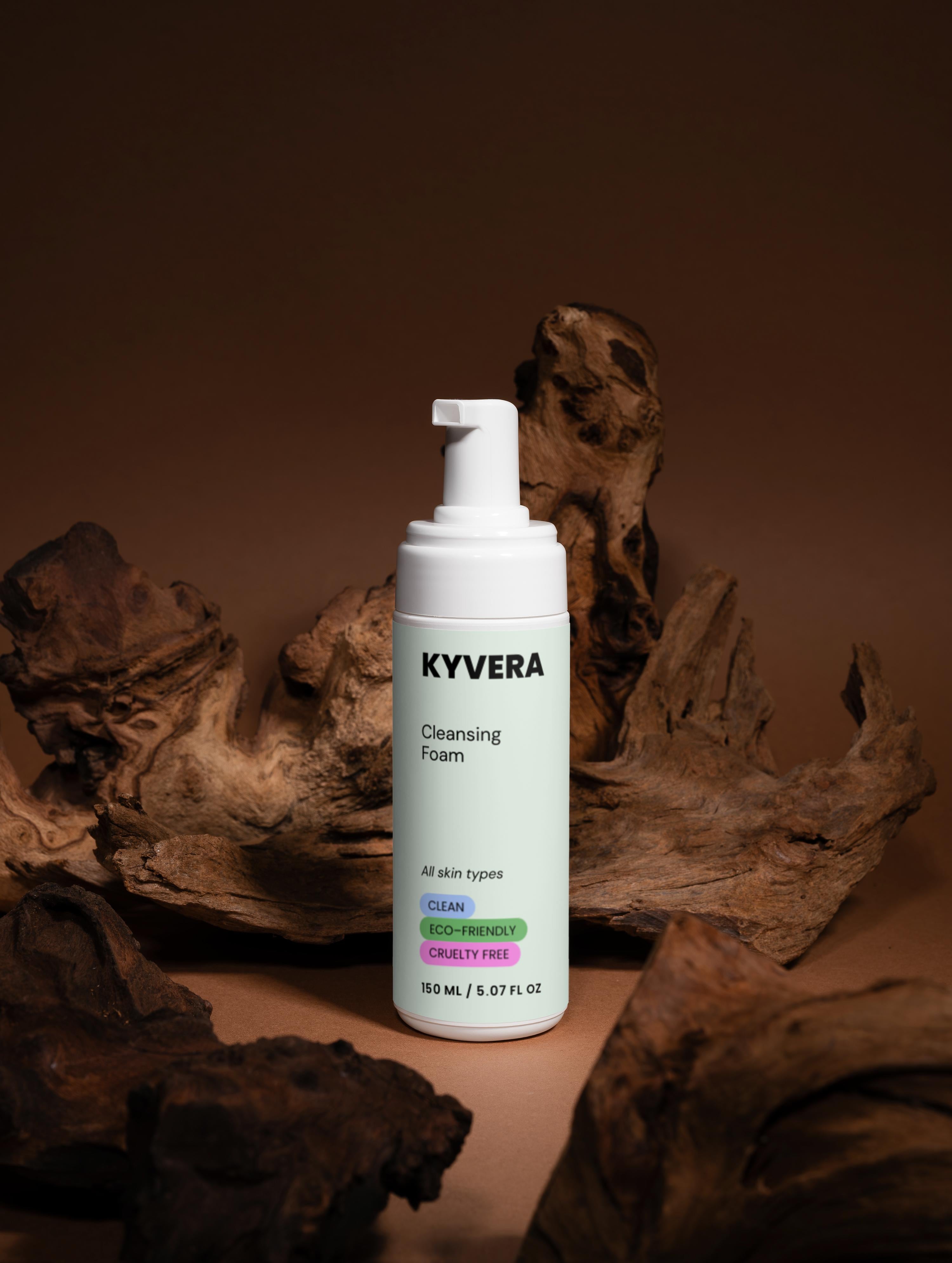 KYVERA Cleansing Foam bottle for gentle face wash against a wood background, promoting clean and fresh skin.