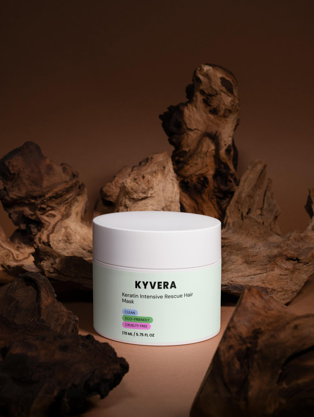 Keratin Intensive Hair Mask in a white jar, displayed among natural wood elements for hair restoration and rejuvenation.