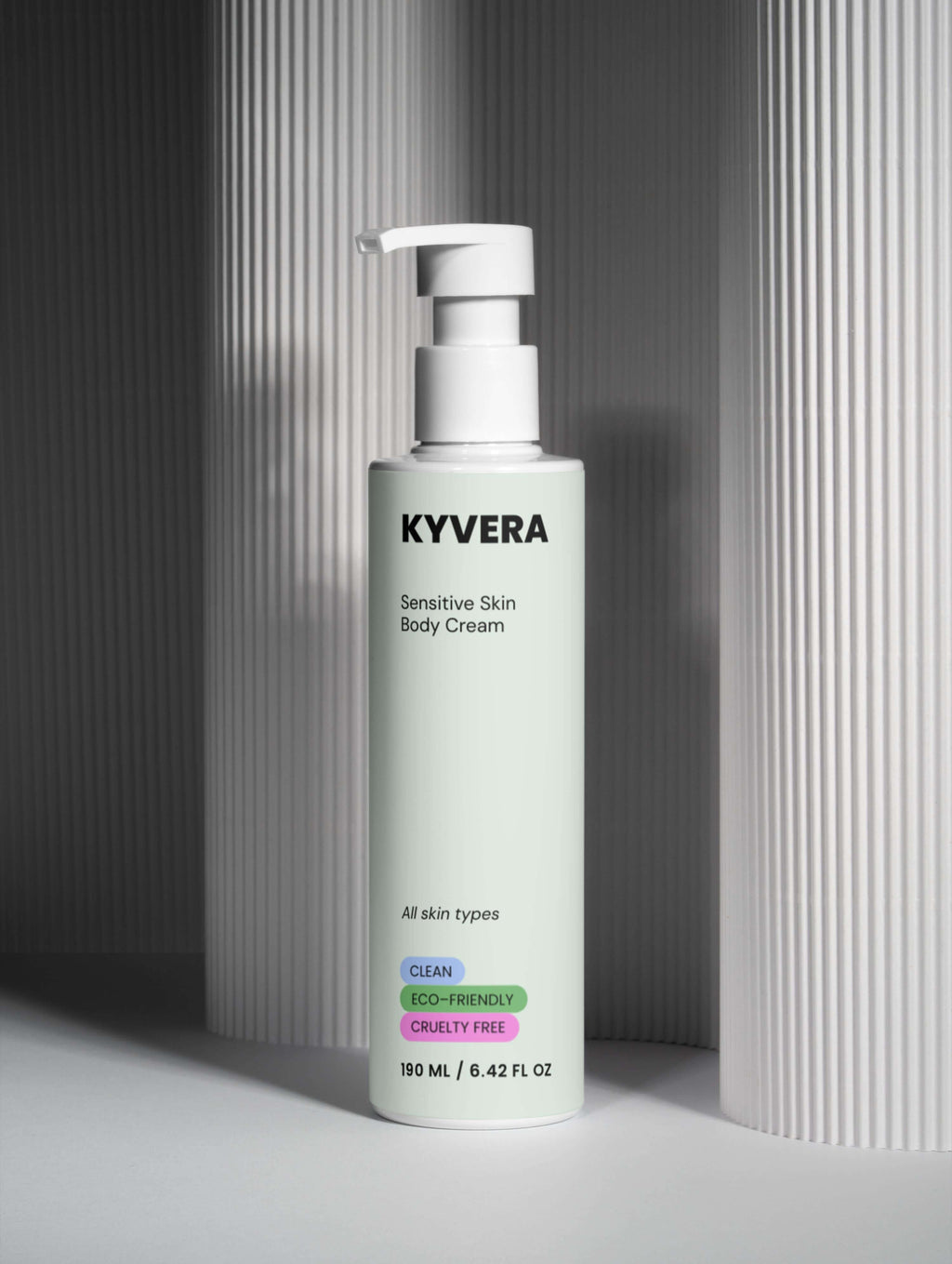 KYVERA Sensitive Skin Body Cream bottle placed against a textured backdrop showcasing its clean and eco-friendly attributes.