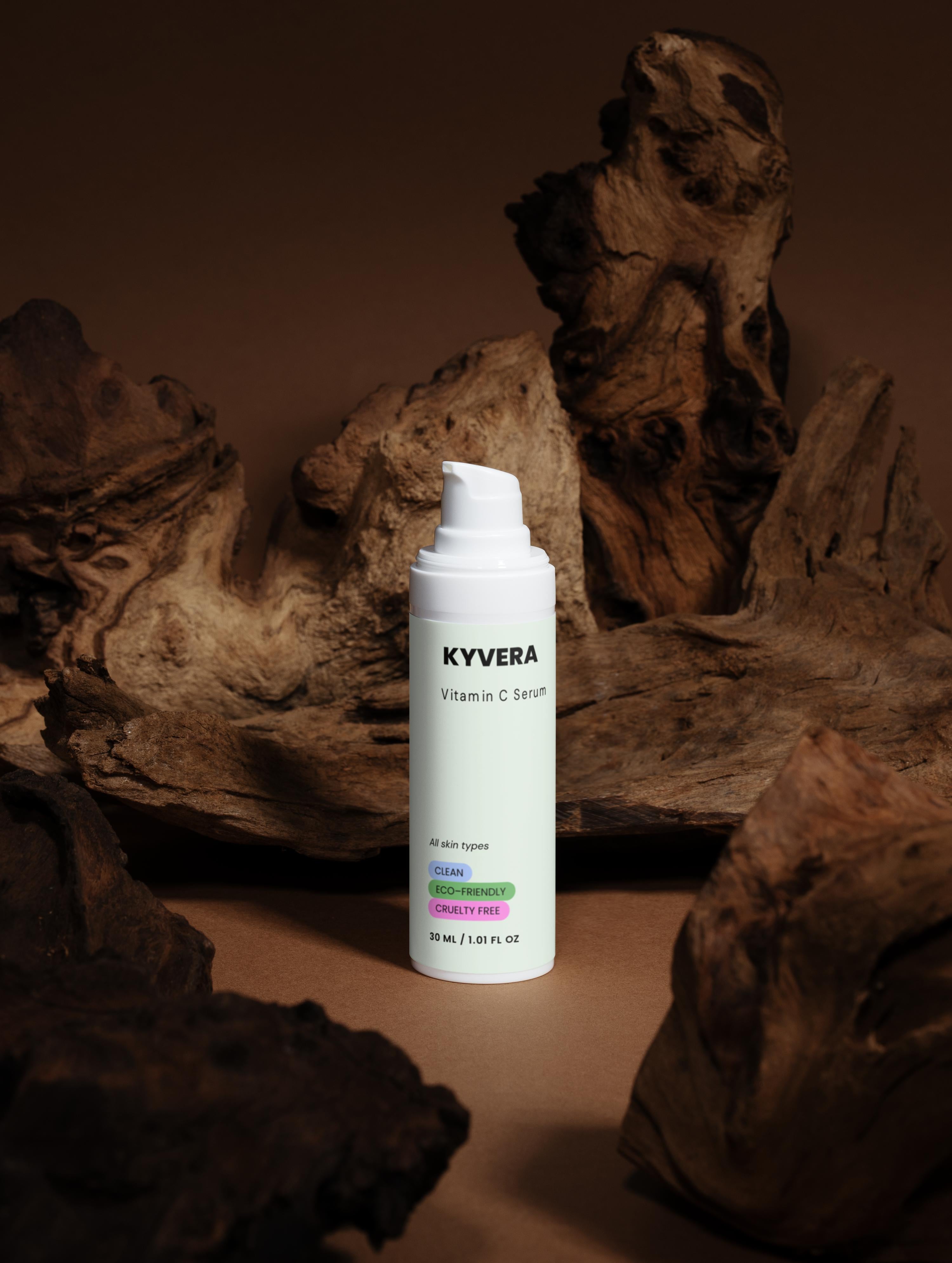 KYVERA Vitamin C Serum bottle on a wooden background, promoting radiant and youthful skin.